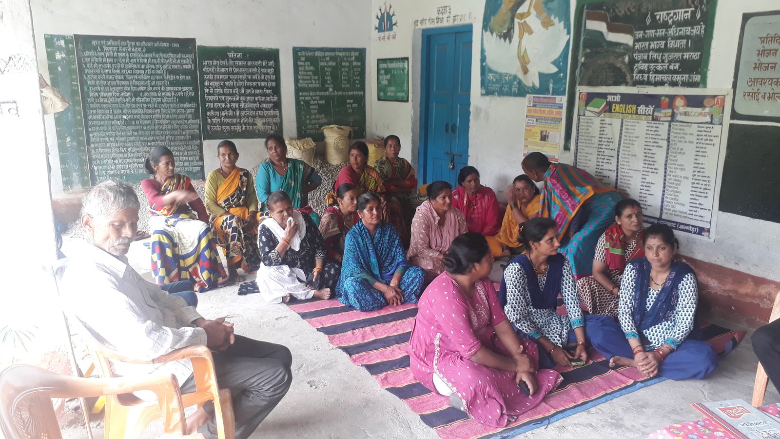 Rural children and women in a village learning session