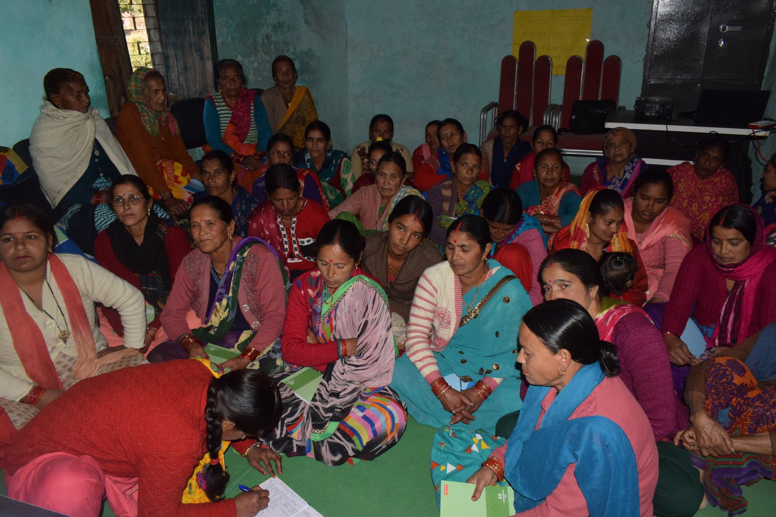 Women taking notes during a capacity building workshop
